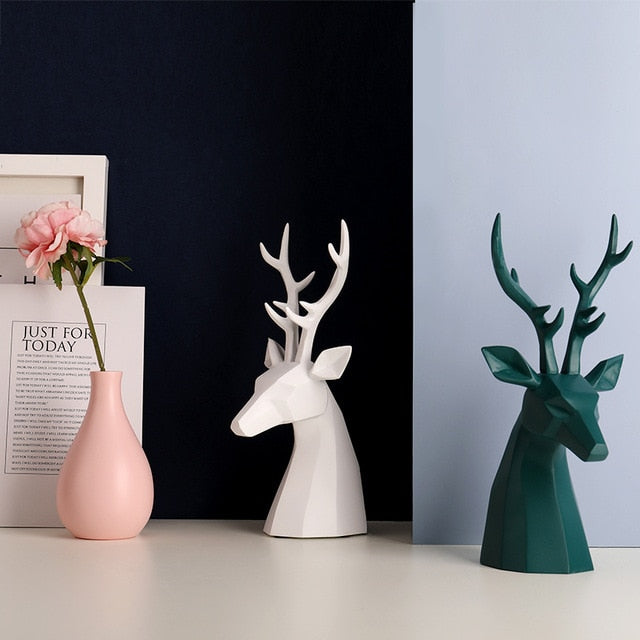A pair of white and green deer figurine tabletop