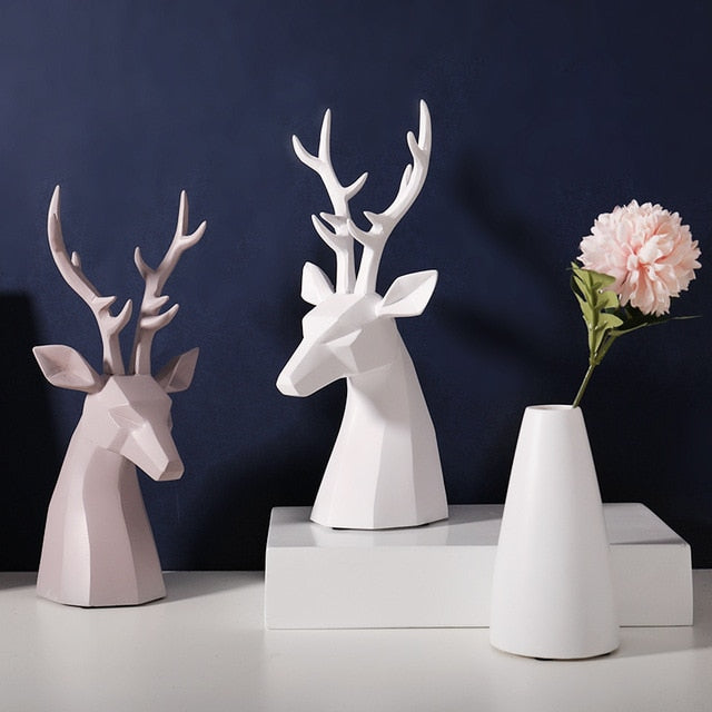 A pair of white and grey deer figurine tabletop