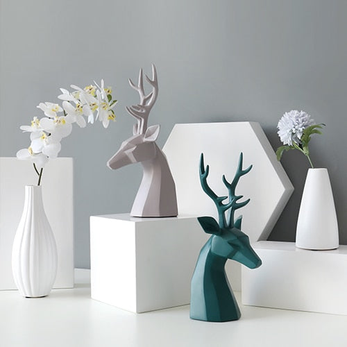 A pair of green and grey deer figurine tabletop